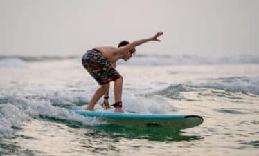 boy surfing in waligama during his sri lanka Holiday tour 2024 with our travel companies list